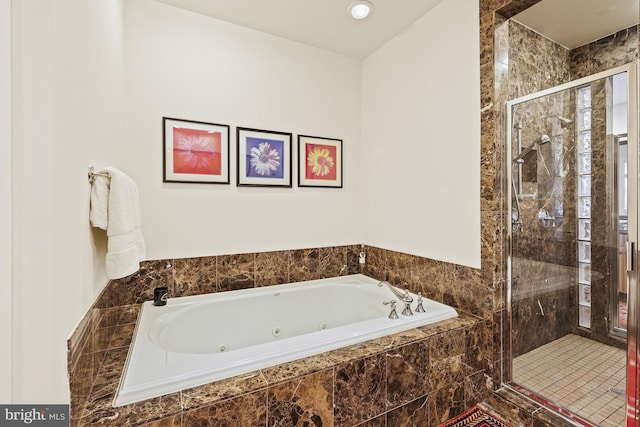 bathroom featuring separate shower and tub