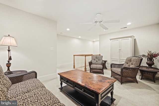 living room featuring light carpet and ceiling fan