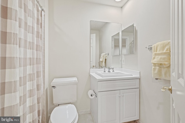 bathroom featuring tile patterned floors, vanity, curtained shower, and toilet