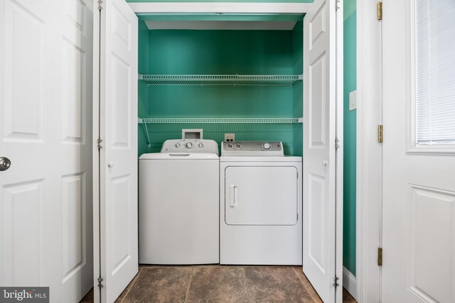 clothes washing area featuring washer and dryer