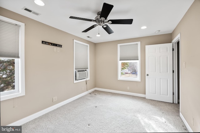 unfurnished bedroom featuring cooling unit, ceiling fan, and light colored carpet