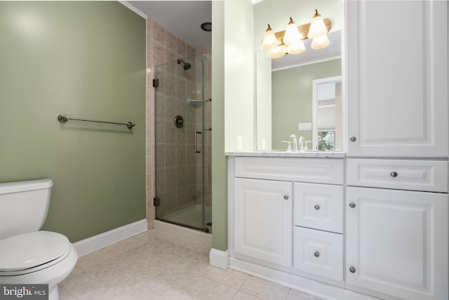 bathroom featuring tile patterned flooring, vanity, toilet, ornamental molding, and a shower with shower door