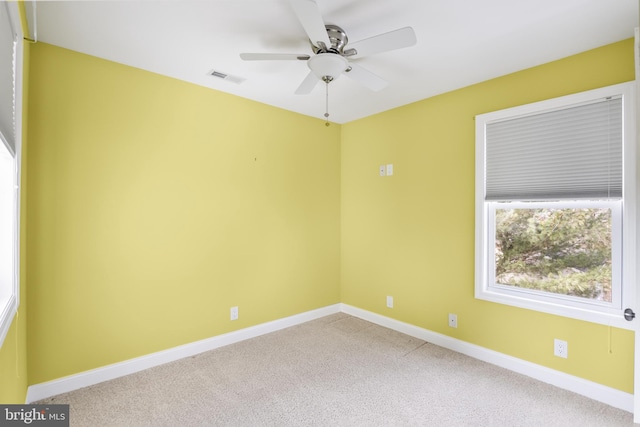 carpeted spare room featuring ceiling fan