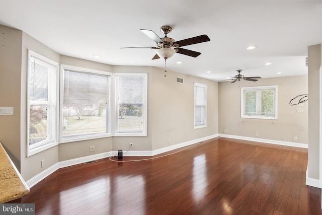 unfurnished living room featuring ceiling fan and dark hardwood / wood-style floors