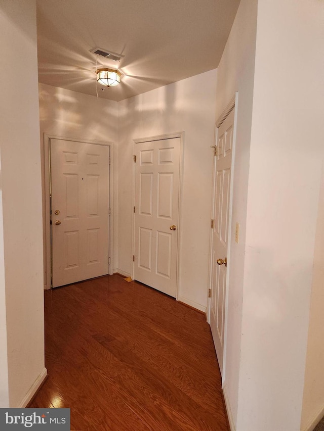 hall with dark hardwood / wood-style flooring