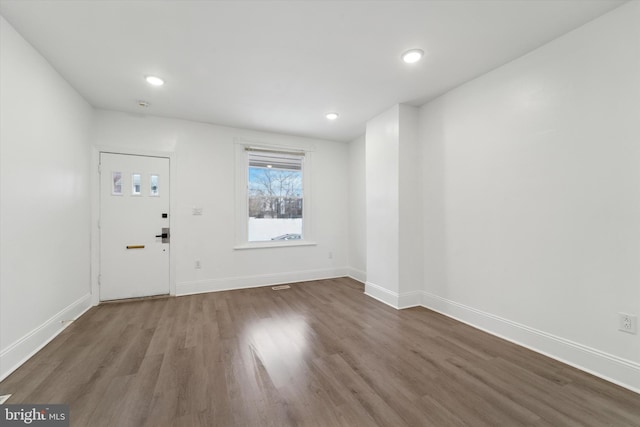 entryway with dark hardwood / wood-style flooring