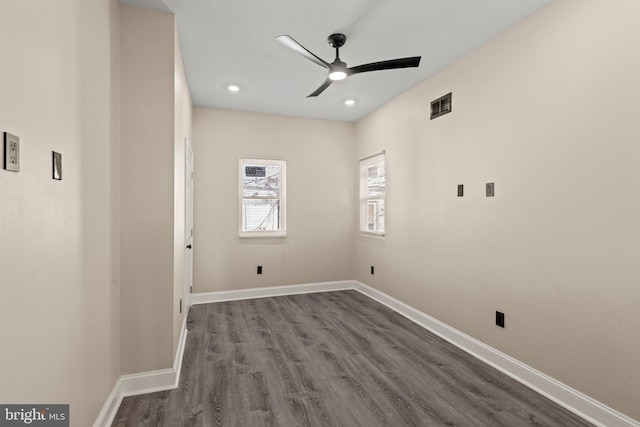 unfurnished room with ceiling fan and dark hardwood / wood-style flooring