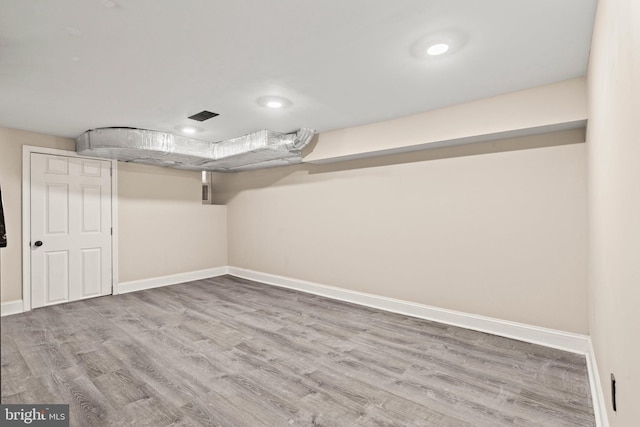 basement featuring hardwood / wood-style flooring