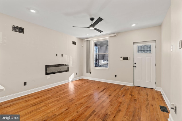 entryway with ceiling fan and light hardwood / wood-style floors