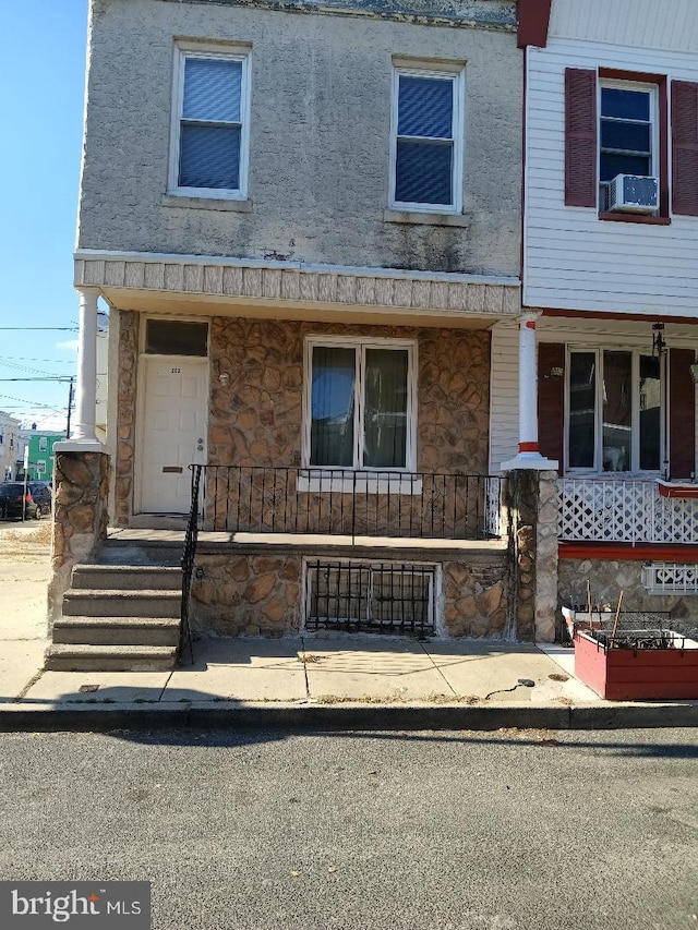 view of front of house featuring covered porch and cooling unit