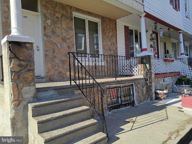 view of exterior entry featuring a porch