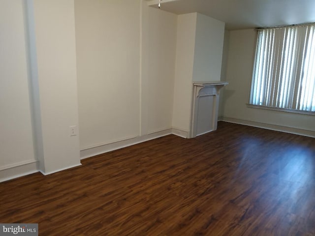 unfurnished living room featuring dark wood-type flooring