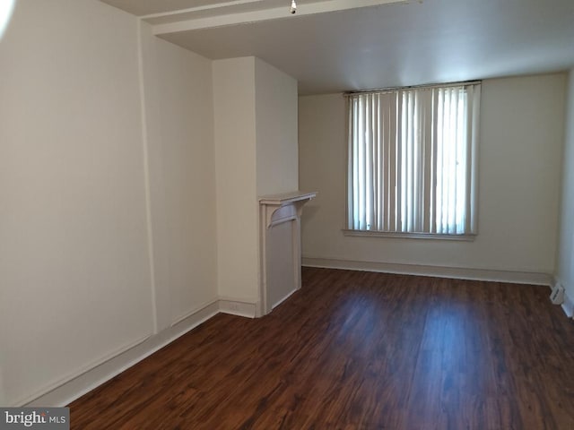 unfurnished living room featuring dark wood-type flooring