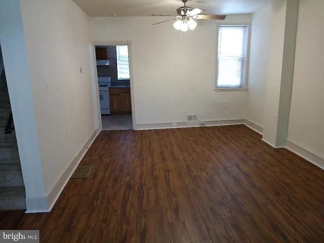 spare room featuring ceiling fan and dark hardwood / wood-style floors