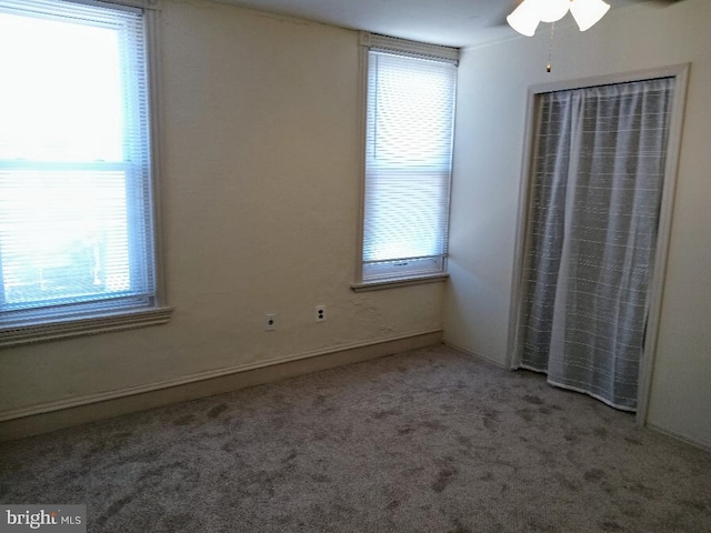 unfurnished bedroom featuring ceiling fan and carpet floors