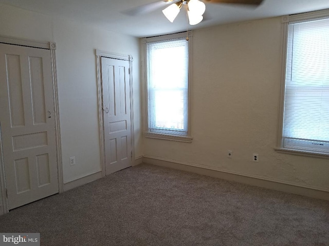 unfurnished bedroom with ceiling fan and carpet floors