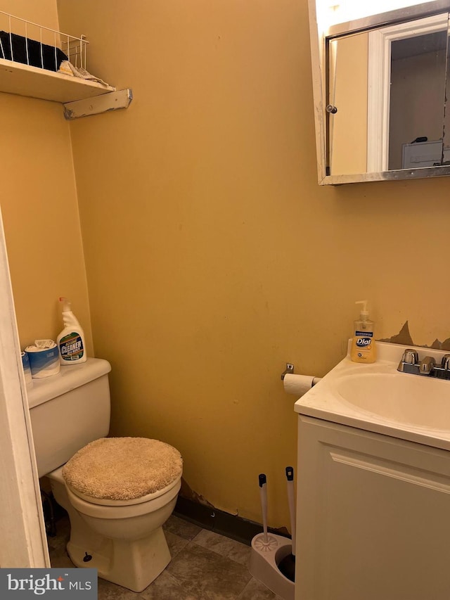 bathroom featuring tile patterned floors, vanity, and toilet