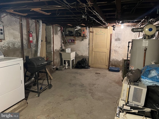 basement featuring washer / dryer, sink, and gas water heater