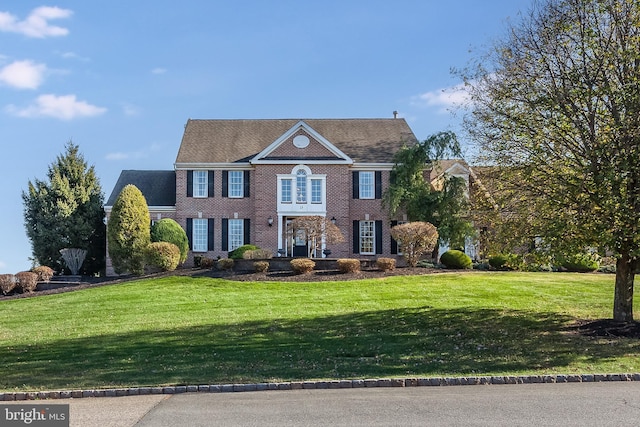 colonial home with a front yard