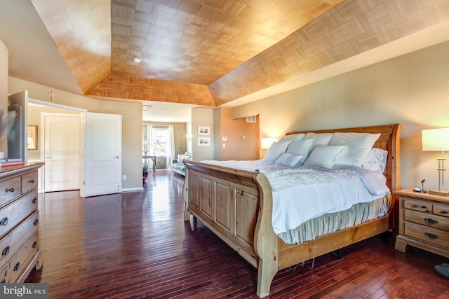 bedroom with vaulted ceiling and dark hardwood / wood-style floors