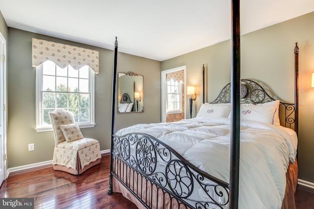 bedroom featuring dark hardwood / wood-style flooring and multiple windows