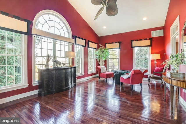 living area with ceiling fan, wood-type flooring, and a wealth of natural light