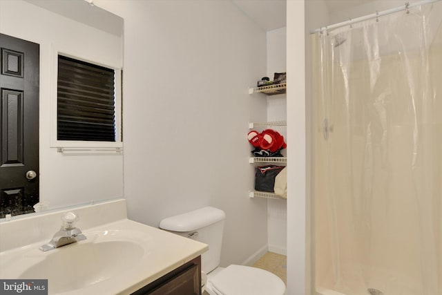 bathroom featuring vanity, a shower with shower curtain, and toilet