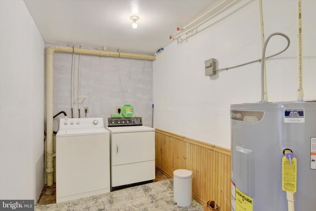 washroom featuring wood walls, independent washer and dryer, and water heater