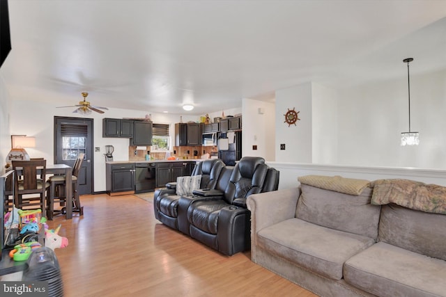 living room with ceiling fan and light hardwood / wood-style floors