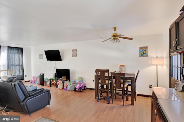 living room featuring ceiling fan and light wood-type flooring