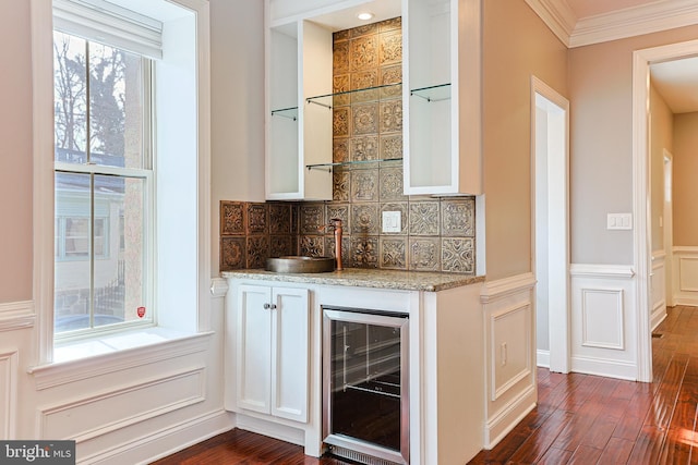 bar with white cabinets, dark wood-type flooring, wine cooler, and backsplash