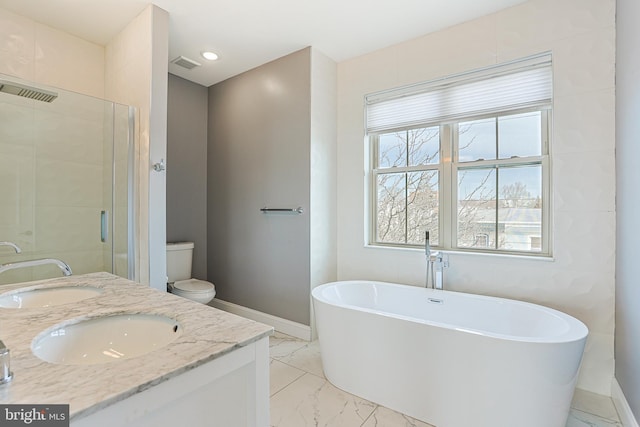 full bathroom with vanity, shower with separate bathtub, and toilet