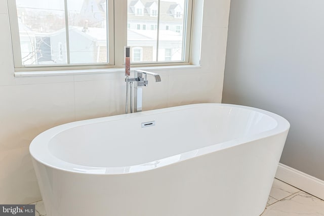 bathroom with a tub to relax in