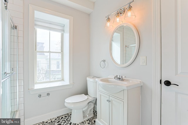 bathroom with vanity, a healthy amount of sunlight, tile patterned floors, and toilet