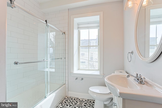 full bathroom with enclosed tub / shower combo, tile patterned floors, toilet, and vanity