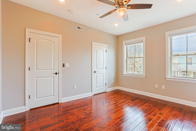 unfurnished bedroom featuring dark hardwood / wood-style flooring and ceiling fan