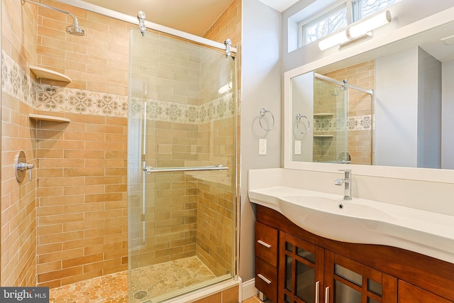 bathroom with vanity and a shower with shower door