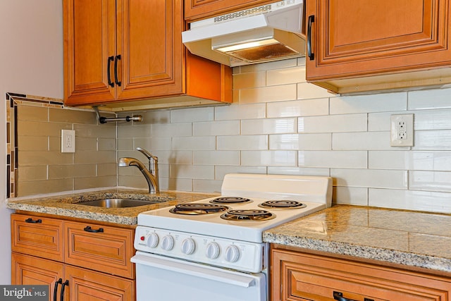 kitchen with light stone counters, white electric stove, sink, and decorative backsplash