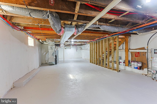 basement featuring water heater and heating unit