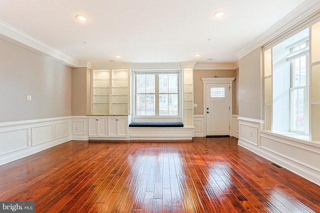 foyer entrance with crown molding and hardwood / wood-style flooring