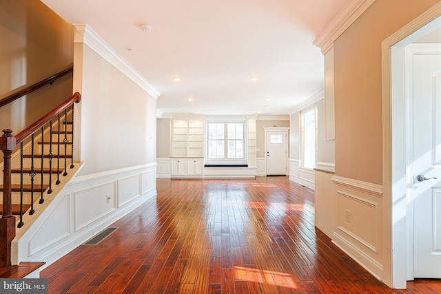 unfurnished living room with crown molding and dark hardwood / wood-style flooring