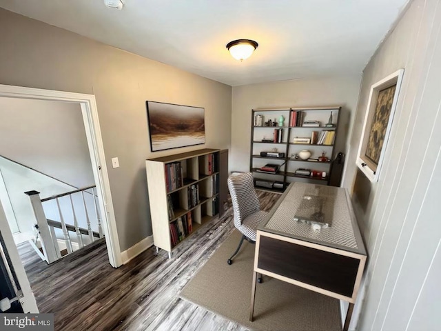 home office with dark hardwood / wood-style floors