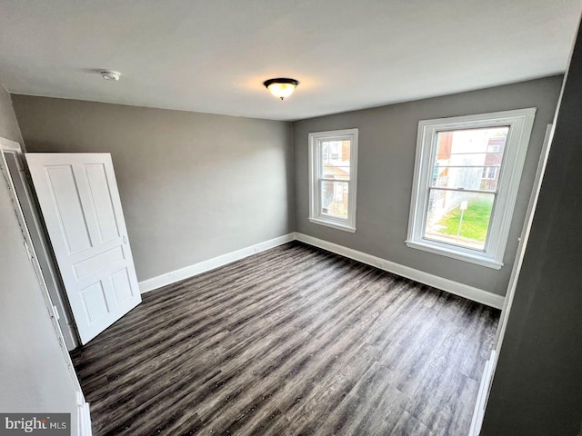 unfurnished bedroom featuring dark hardwood / wood-style flooring