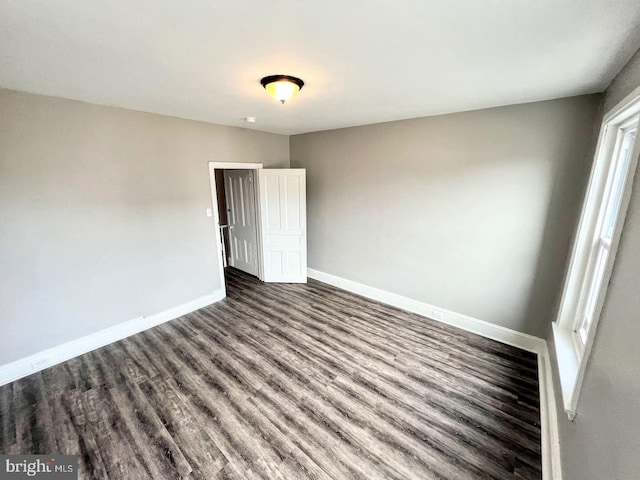 unfurnished bedroom featuring dark hardwood / wood-style flooring