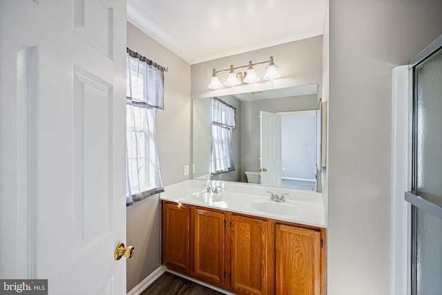 bathroom featuring hardwood / wood-style floors, vanity, and toilet