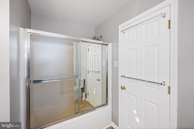 bathroom featuring shower / bath combination with glass door