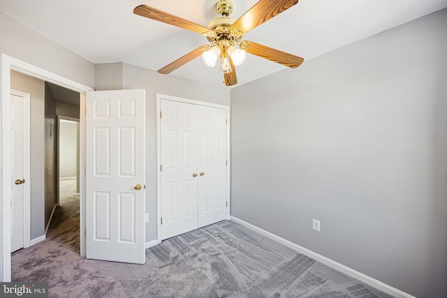 unfurnished bedroom featuring carpet floors, a closet, and ceiling fan