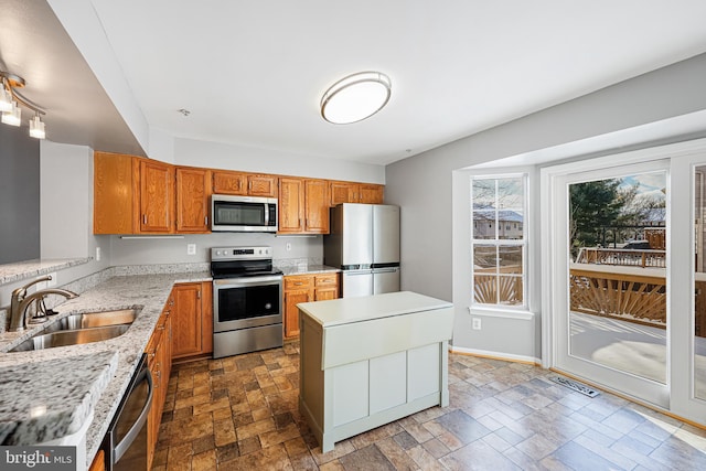 kitchen with a kitchen island, sink, and stainless steel appliances