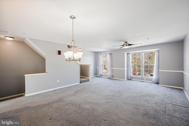 unfurnished living room featuring ceiling fan with notable chandelier and carpet floors