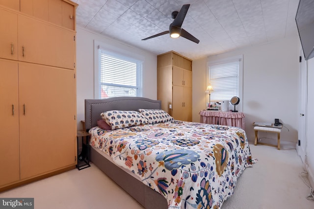 bedroom featuring ceiling fan and light colored carpet